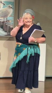 A woman with a hand to her ear