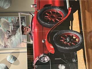 A man in a red old car