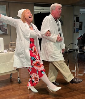 A woman dressed as a nurse and a man dressed as a doctor, singing