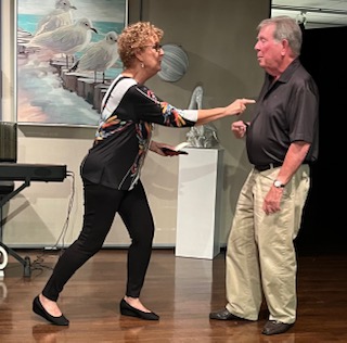 A woman poking a man in the chest