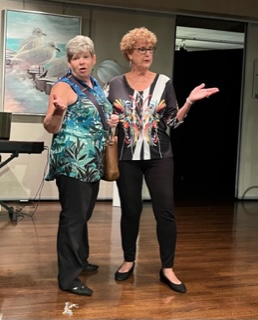 Two women with their hands up