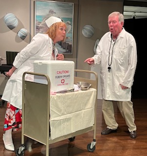 A woman dressed as a nurse talking to a man dressed as a doctor