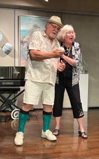 A man and woman hugging and singing