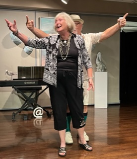 A man and woman with hands up